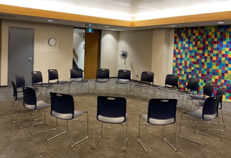 Chairs arranged in a circle inside the Auditorium at New Westminster Public Library's Main Branch.