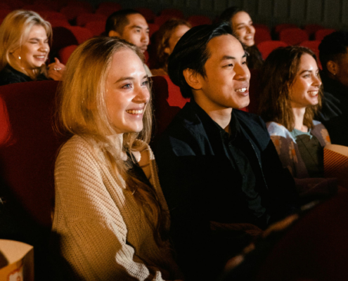 Audience members smile.